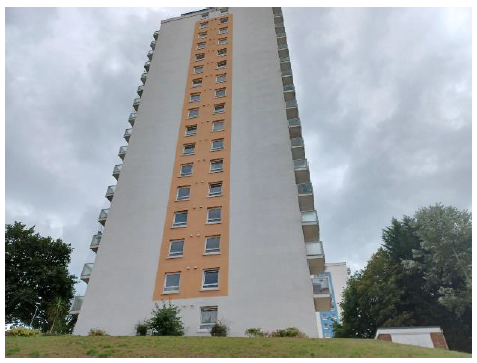 A tower block against a grey sky