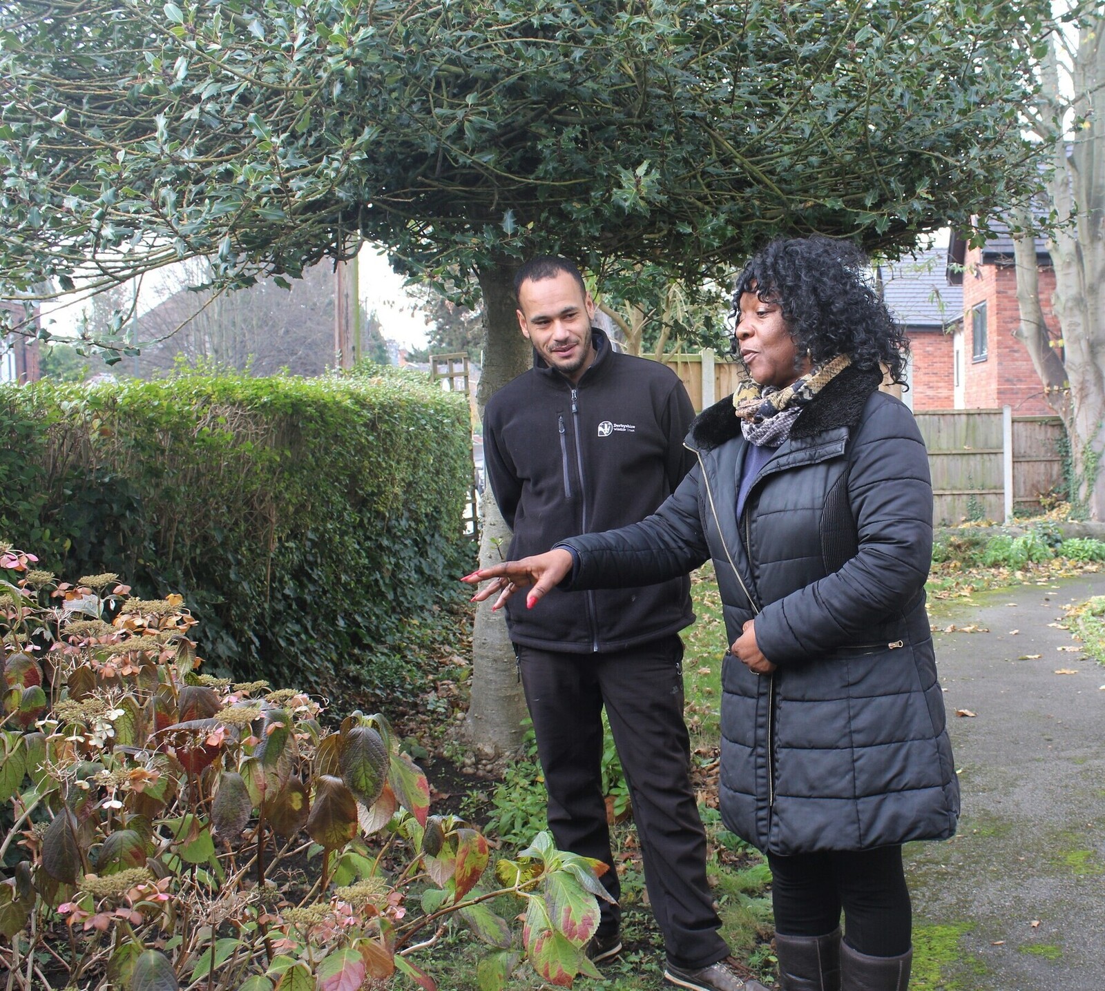 A man and a woman talking in a wintery garden