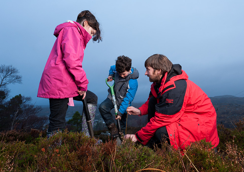 Children from Lochinver primary school planting trees at Culag Wood with Andy Summers
